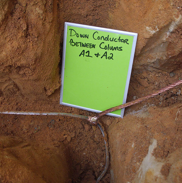 Tagged down conductor in a grounding trench
