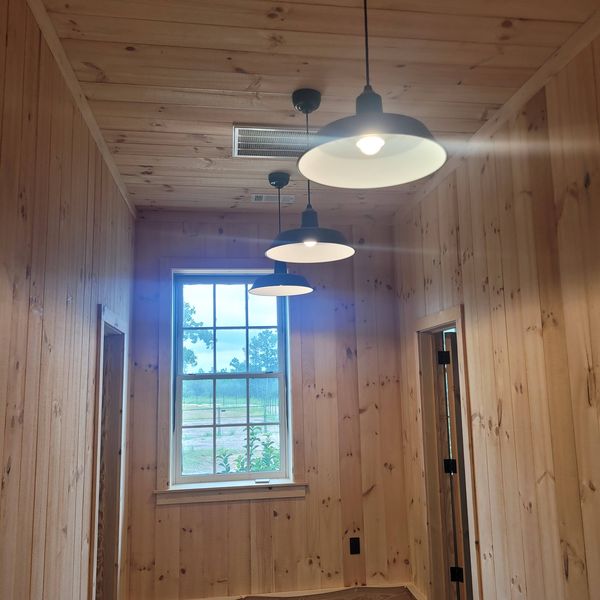 Pendant fixtures in a wood-paneled room