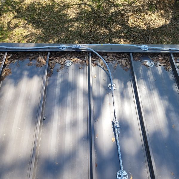 Conductor and clips along a roof edge